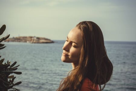 Portrait of young beautiful woman in sunset light