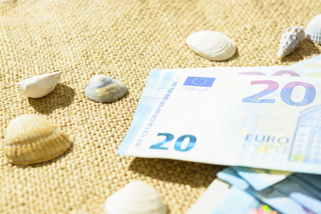 Euro banknotes, passports and shells on a linen background. the concept of travel.の写真素材