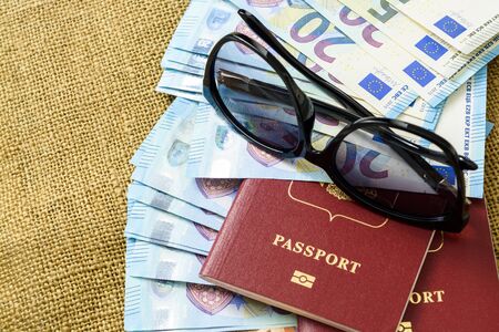 Passports with european union currency and sunglasses on a map background. Travel conceptの写真素材