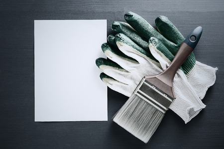 Gloves with paint brush with copy space. black and white tonedの写真素材
