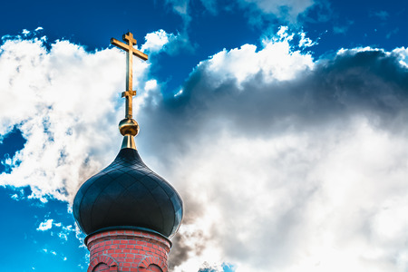 Dome with a golden cross on top of the building of the Orthodox chapel. The dome of the church. The Christian crossの写真素材
