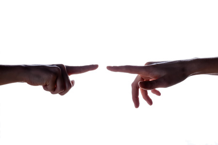 Isolated image of a silhouette of the boy's hands reaching for the woman's hand. Hands of mother and son. The concept of family, support, help, loveの写真素材