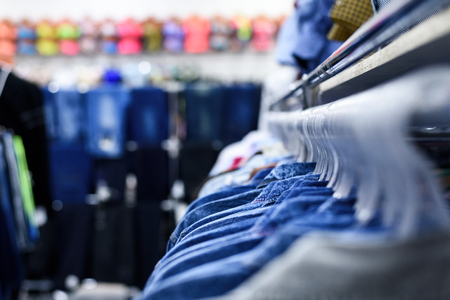 Denim shirts hang on hangers in a row. Clothes Shop. Style Concept.の写真素材