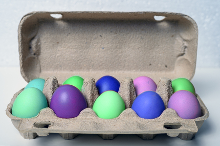 Front view of the container with multicolored eggs.