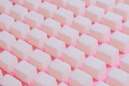Geometric pattern with refined sugar on a pink background.の写真素材