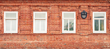 Banner with red brick wall and white vintage windows.の写真素材