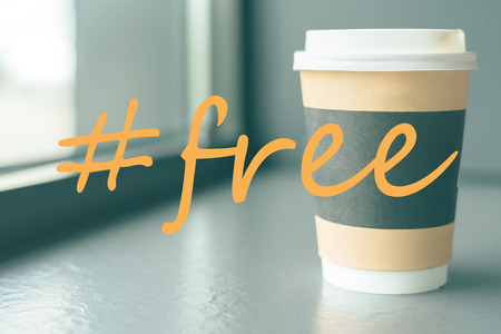 A cardboard Cup of coffee on the coffee windowsill with a hashtag is free of Charge.の写真素材