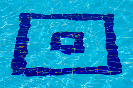 Blue square target under blue water of the pool