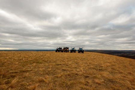 Panoramic view of four Quad bikes in the field, cloudy dayの写真素材