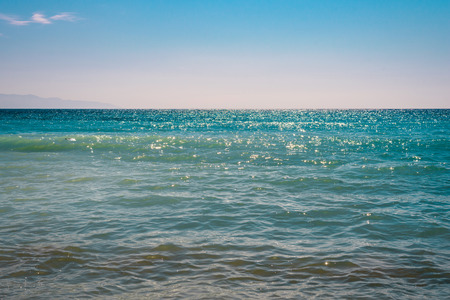 Minimalistic landscape of turquoise sea water in calm with blue sky.の写真素材