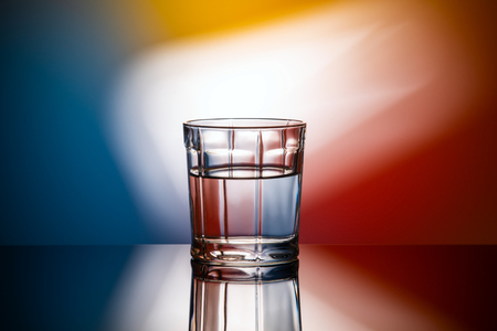 horizontal abstract image glass of water on multicolored backgroundの写真素材