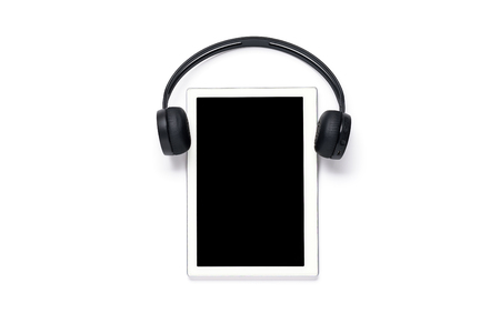 Tablet with wireless headphones on a white isolated background, layout, concept of modern education, technologyの写真素材