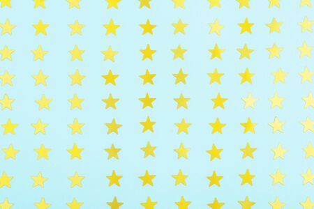 pattern of gold stars on blue background, shiny abstract starry backdropの写真素材