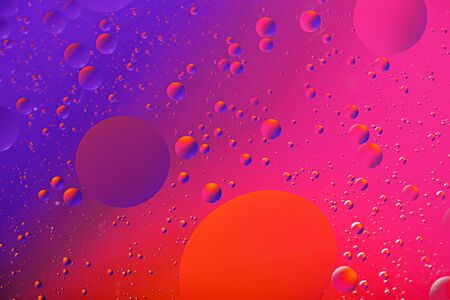 art background of oil drops on the water surface on colorful gradient background for wallpaper,...
