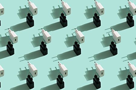 trendy pattern of black and white chargers on pastel turquoise backgroundの写真素材