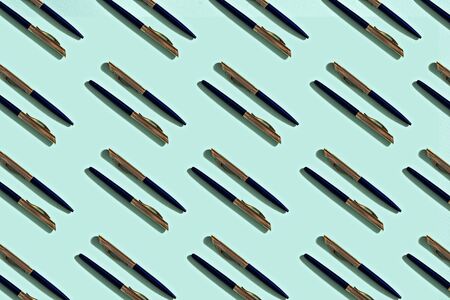 pattern of ballpoint pens on mint background, stationery concept
