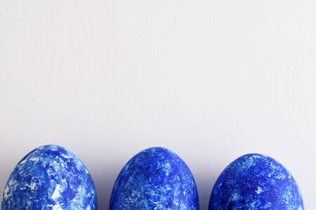 abstract three classic blue eggs on white background for Easterの写真素材