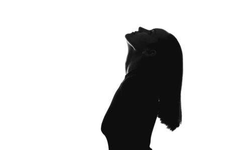 trendy black and white portrait silhouette of woman on side with his head thrown backの写真素材