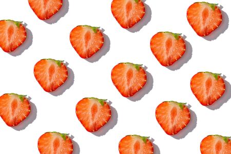 strawberry slices on white background, summer strawberry background concept, top view, flat layの写真素材