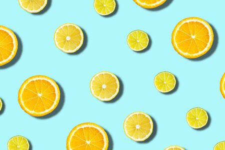 citrus on blue background, oranges, limes slices, top view, flat lay