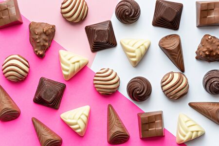 art chocolate candies on white pink background, world chocolate day concept, top viewの写真素材