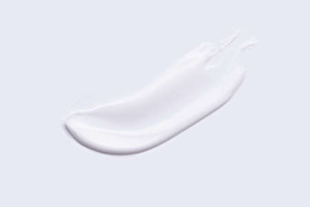 white cream smear on white background, top view, self-care conceptの写真素材