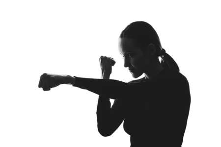 trendy black and white silhouette portrait of woman, strike, defense conceptの写真素材
