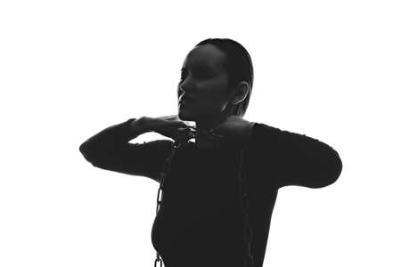 black white silhouette portrait of woman with chain around her neck, domestic violence concept, suffocation,の写真素材