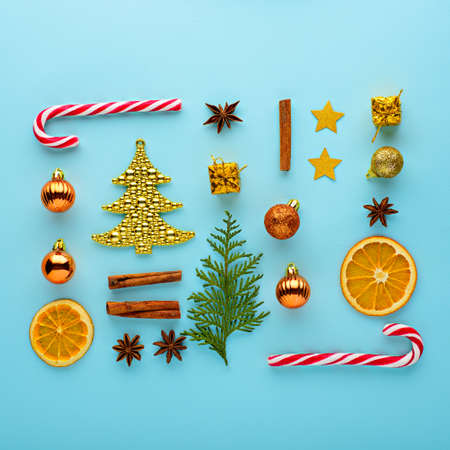 Christmas composition. Candy, decorations, toys on blue background, top view, flat lay festive...