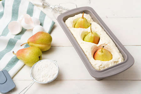 process of preparation pie with whole pears on white background, pound pear cake, home cookingの写真素材