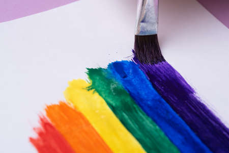 drawing rainbow, rainbow stripes with watercolor paint using brush, closeup, lgbtq symbol conceptの写真素材