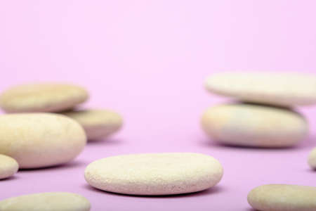heap of stones, pebbles on very peri background, podium for product presentation with selective...