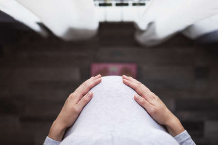 top view pregnant woman stands on scales, measurement, weight control during pregnancy, healthy and happy pregnancy conceptの写真素材