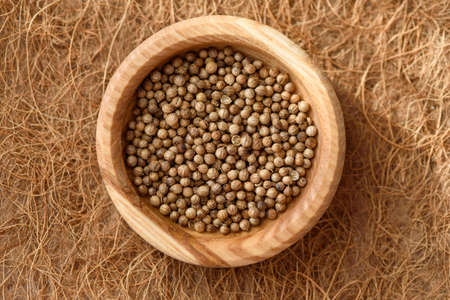 top view seeds in wooden plate on coconut fibrous background, summer season, planting seeds,...