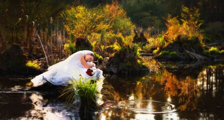 Beautiful bride dreams of the lakeの写真素材