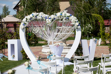 Arch and chairs at wedding ceremony outdoorの写真素材