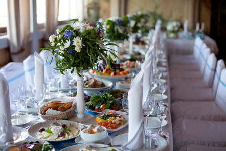 Served for a banquet table. Wine glasses with napkins, glasses and salads.の写真素材
