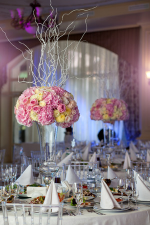 Table setting at a luxury wedding reception. Beautiful flowers on the table.の写真素材