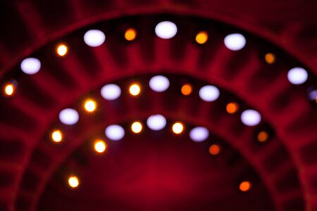 Colorful lights on red background. Defocused.の写真素材