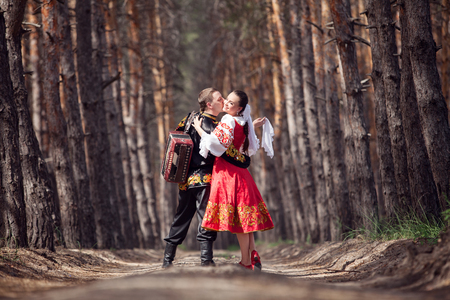 Man and woman with an accordion in the Russian national dressの写真素材