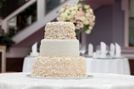 Beautiful wedding cake on the table in restaurantの写真素材