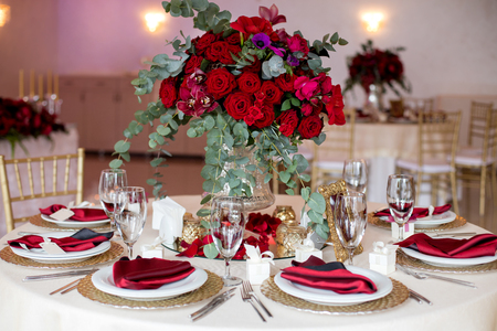 Table setting at a luxury wedding reception. Beautiful flowers on the table.の写真素材