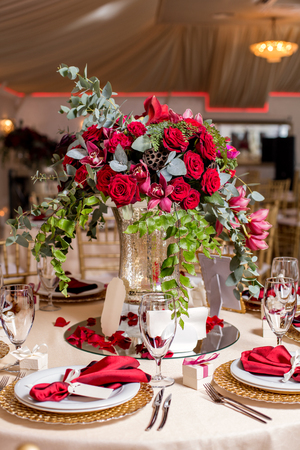 Table setting at a luxury wedding reception. Beautiful flowers on the table.の写真素材