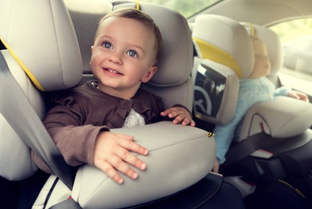 Small children in car seats in the carの写真素材