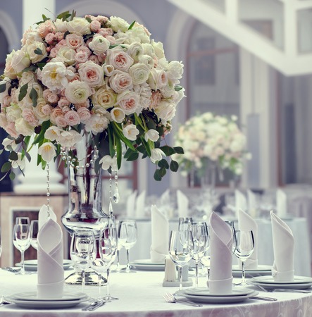 Table set for an event party or wedding reception. Beautiful flowers on the table.の写真素材