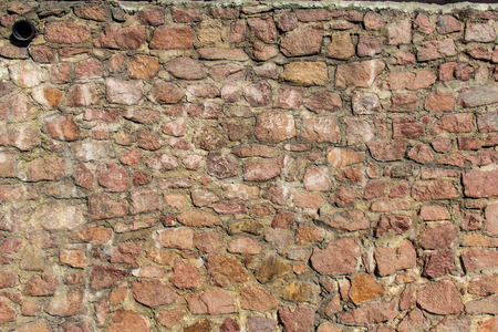 Thick and powerful wall of stone, from a distance it looks completely red and impregnableの写真素材