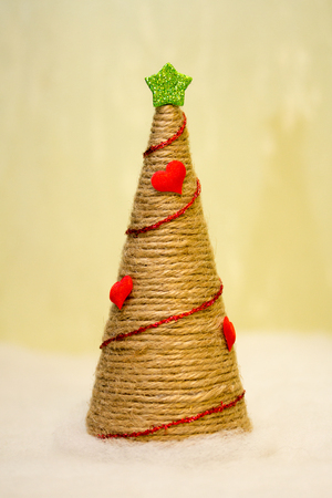 Gorgeous Christmas tree with his hands made of twine, decorated with hearts and garlandの写真素材