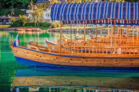 Boat taxi parked at Bled lake with reflection.の写真素材