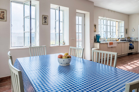 Modern kitchen Provence style with bowl of apples and blue white tablecloth, Israel.のeditorial素材