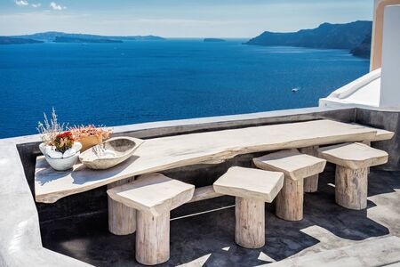 View from a restaurant terace in Oia the most beautiful village of Santorini island in Greeceの写真素材